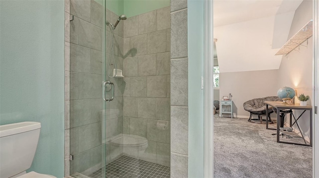 bathroom featuring an enclosed shower, toilet, and lofted ceiling