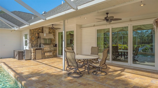 view of patio featuring area for grilling, ceiling fan, and an outdoor kitchen