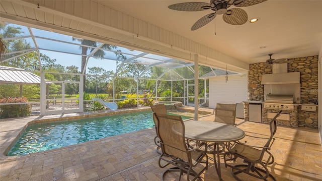 view of pool featuring glass enclosure, a patio area, a water slide, area for grilling, and ceiling fan