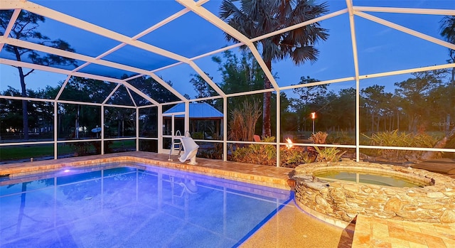 view of swimming pool featuring a water slide, glass enclosure, and an in ground hot tub