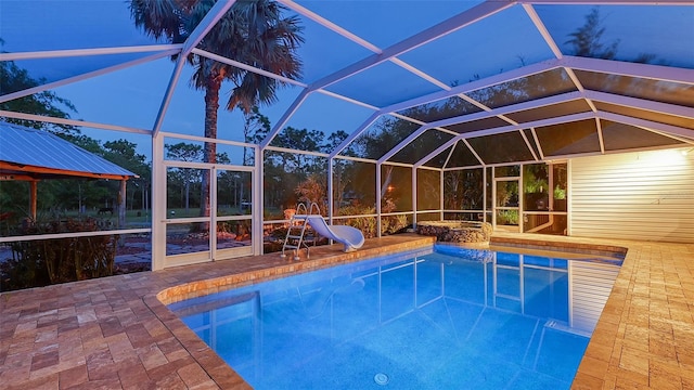 view of pool with a patio area, a lanai, and a water slide