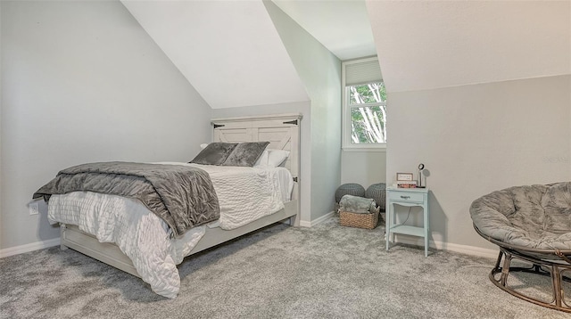 carpeted bedroom with lofted ceiling