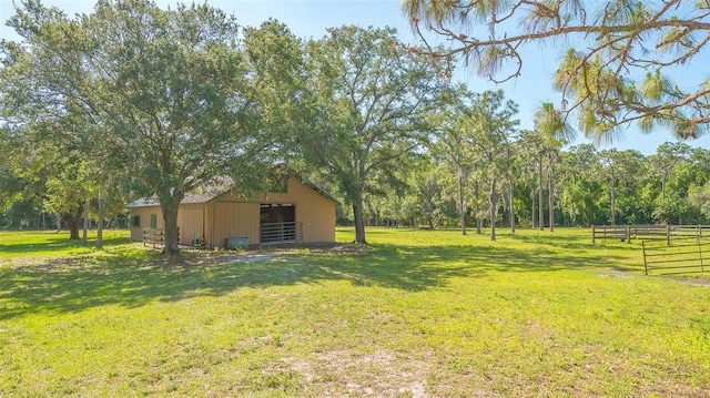 view of yard featuring a rural view and an outdoor structure