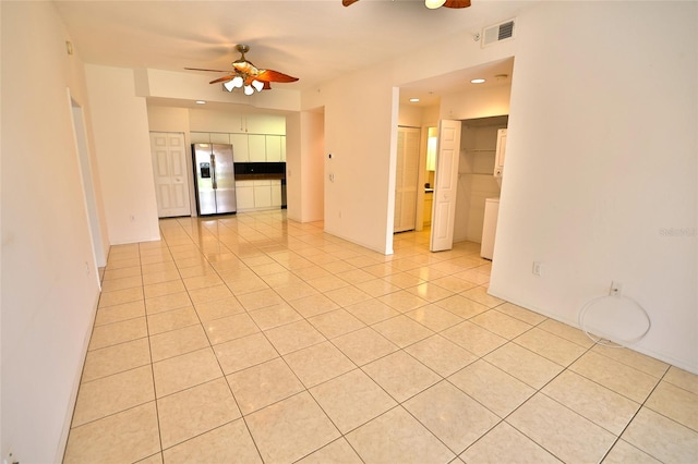 empty room featuring ceiling fan and light tile patterned floors