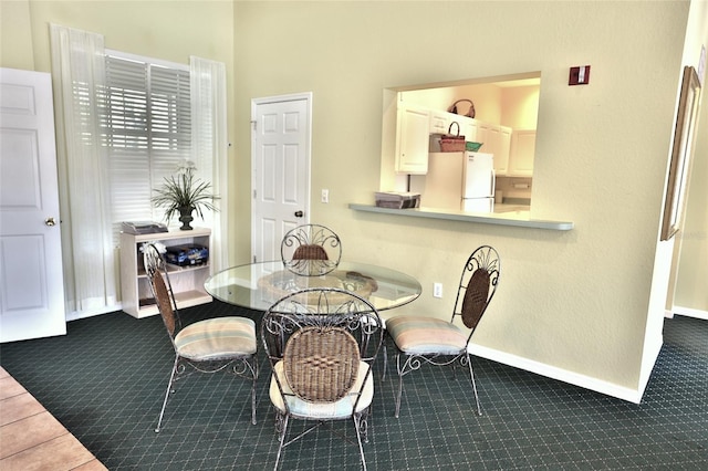 dining area featuring dark carpet