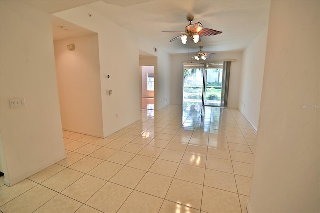 tiled empty room with ceiling fan