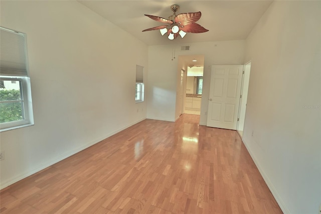 empty room featuring ceiling fan and light hardwood / wood-style floors