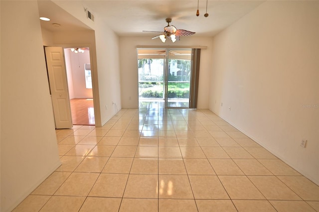 tiled empty room with ceiling fan