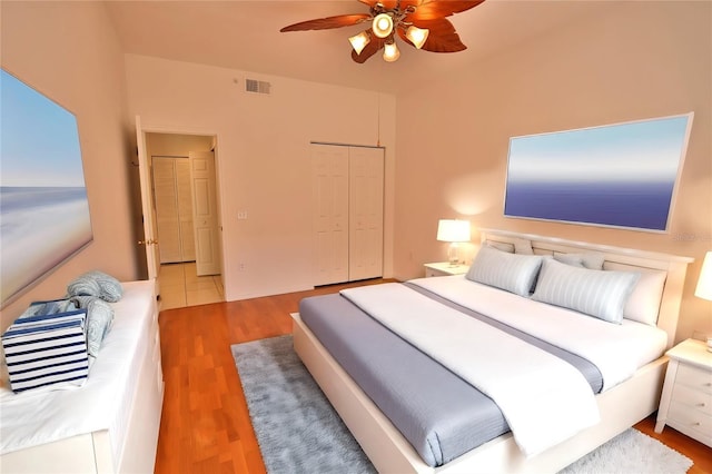 bedroom with hardwood / wood-style floors, a closet, and ceiling fan