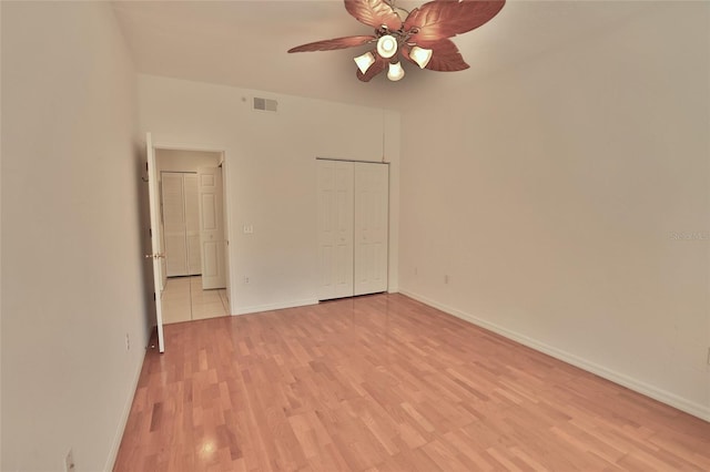 unfurnished bedroom with a closet, ceiling fan, and light hardwood / wood-style flooring