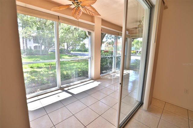 unfurnished sunroom with ceiling fan