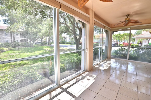 unfurnished sunroom featuring ceiling fan