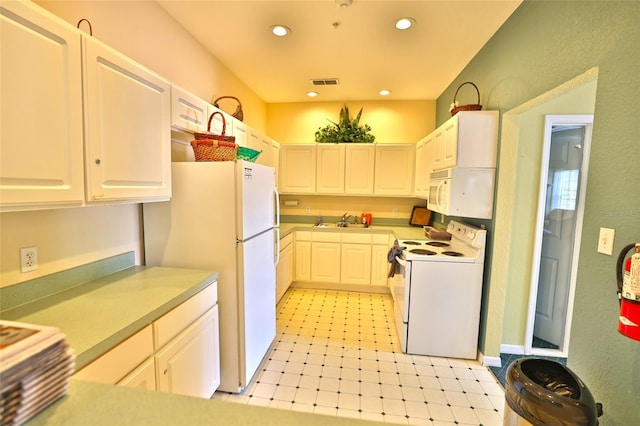 kitchen with white cabinetry, sink, and white appliances