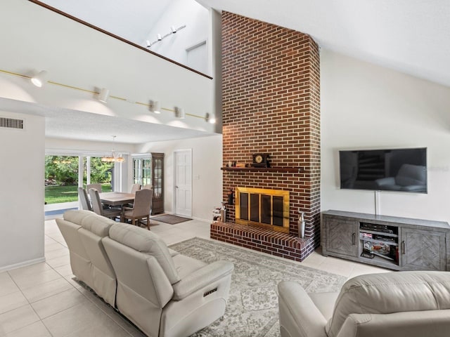 tiled living room featuring a brick fireplace and high vaulted ceiling