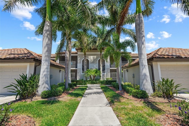 mediterranean / spanish-style house with a garage