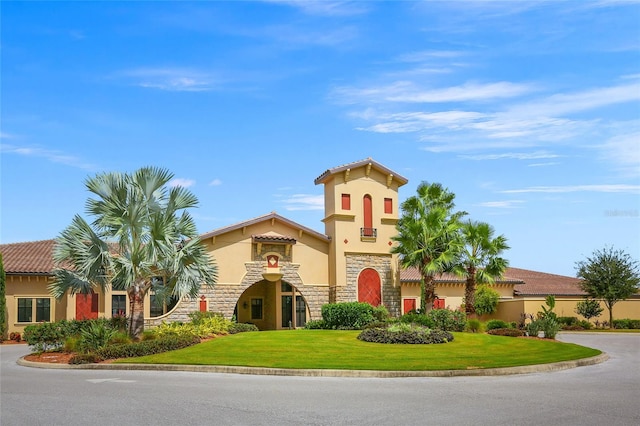 mediterranean / spanish-style home featuring a front lawn