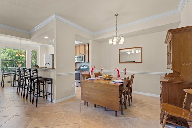 tiled dining area with crown molding, sink, and an inviting chandelier