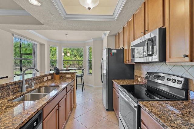 kitchen with dark stone countertops, crown molding, sink, and appliances with stainless steel finishes