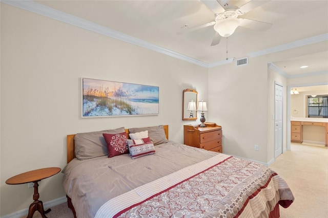 bedroom with ceiling fan, light colored carpet, crown molding, and connected bathroom