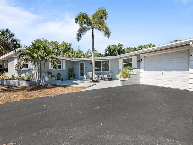 ranch-style home featuring a garage