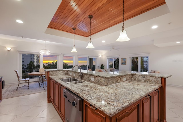 kitchen with sink, dishwasher, hanging light fixtures, and a raised ceiling