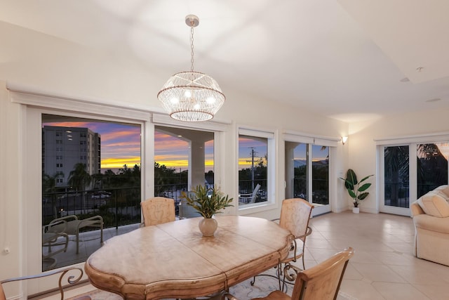 tiled dining space with an inviting chandelier