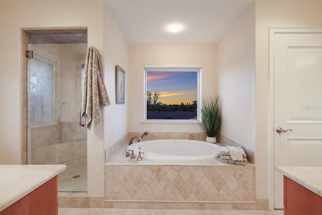 bathroom featuring independent shower and bath, vanity, and tile floors