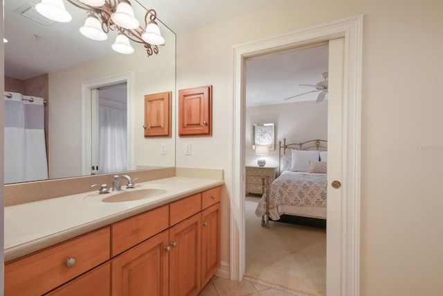 bathroom with ceiling fan with notable chandelier, tile flooring, and vanity