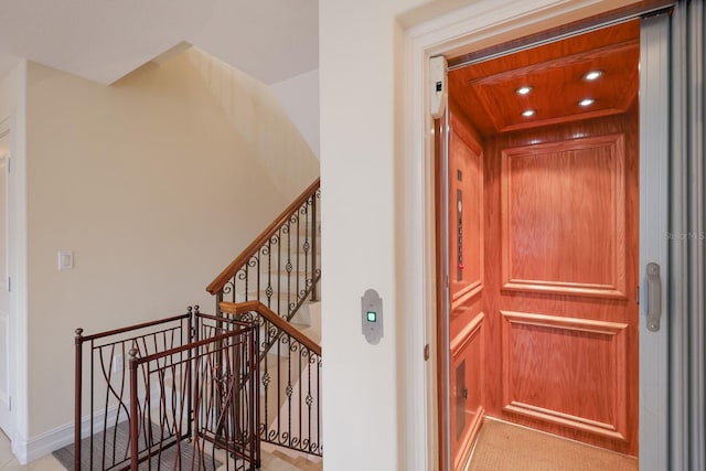 interior space with wood ceiling, carpet, and elevator