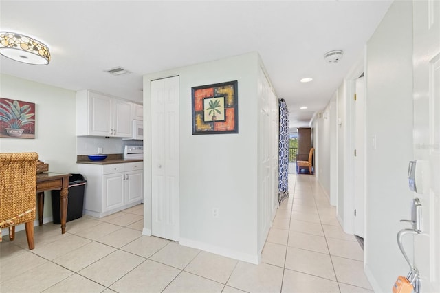 hallway featuring light tile floors