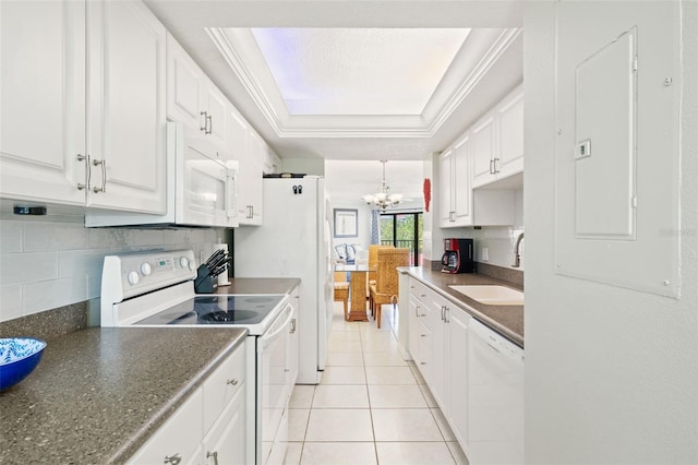 kitchen featuring white cabinets, white appliances, backsplash, a raised ceiling, and an inviting chandelier