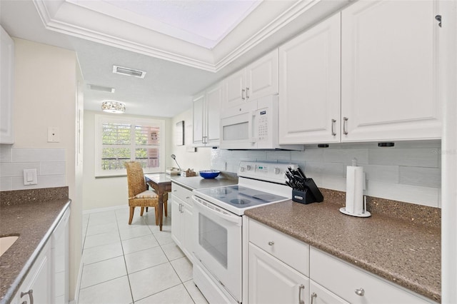 kitchen featuring white cabinetry, tasteful backsplash, crown molding, and white appliances