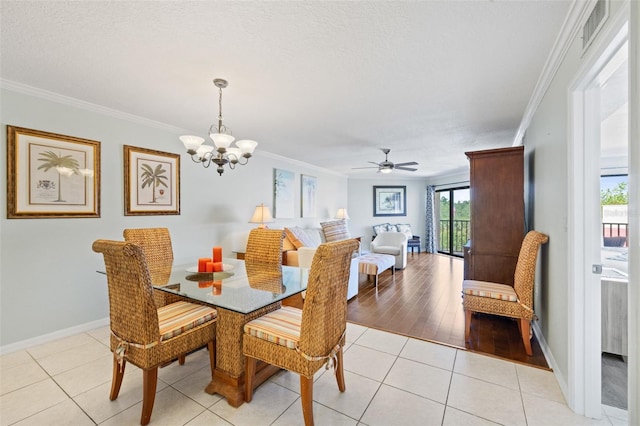 dining area with ceiling fan with notable chandelier, light tile flooring, and ornamental molding