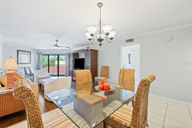 tiled dining area with ceiling fan with notable chandelier and crown molding