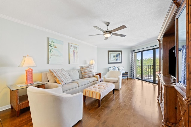 living room with ceiling fan, crown molding, dark hardwood / wood-style floors, and a textured ceiling