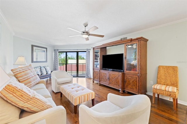 living room with ornamental molding, wood-type flooring, and ceiling fan