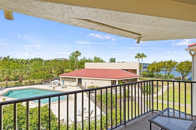 balcony featuring a fenced in pool