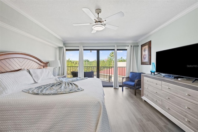 bedroom featuring ornamental molding, hardwood / wood-style flooring, access to outside, and a textured ceiling