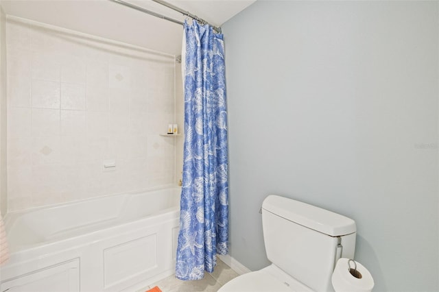 bathroom with tile flooring, shower / tub combo, and toilet