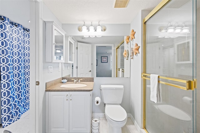 bathroom featuring a shower with door, vanity, tile flooring, toilet, and a textured ceiling