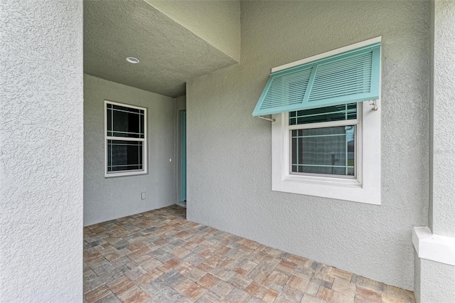 view of exterior entry featuring a patio area