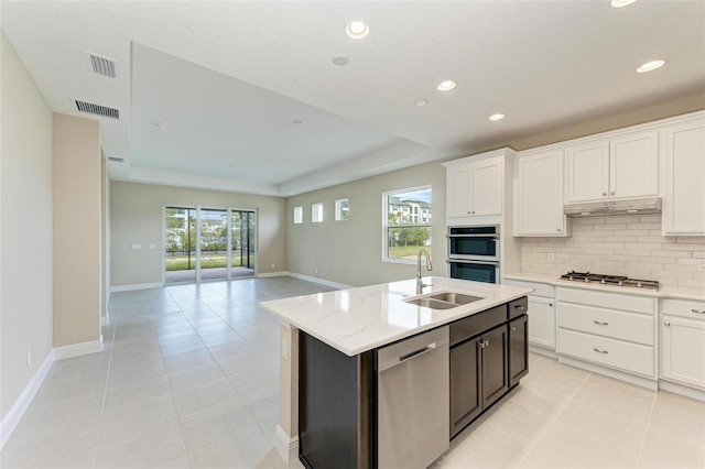 kitchen featuring backsplash, plenty of natural light, sink, and stainless steel appliances