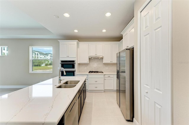 kitchen featuring sink, appliances with stainless steel finishes, backsplash, and white cabinetry