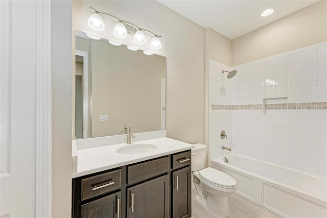 full bathroom featuring vanity, toilet, tile floors, and tiled shower / bath combo