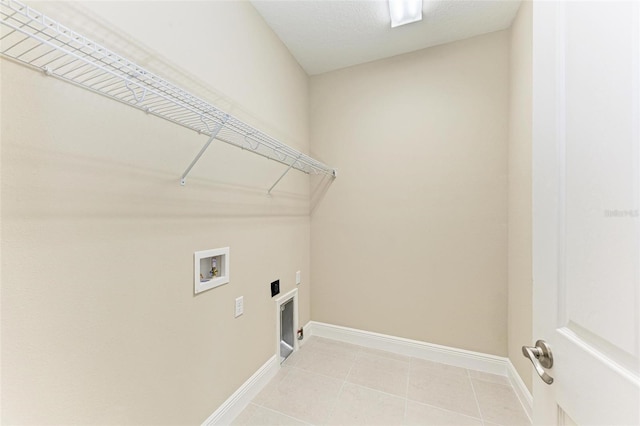 clothes washing area featuring hookup for an electric dryer, light tile flooring, and hookup for a washing machine