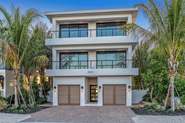 modern home with a balcony and a garage