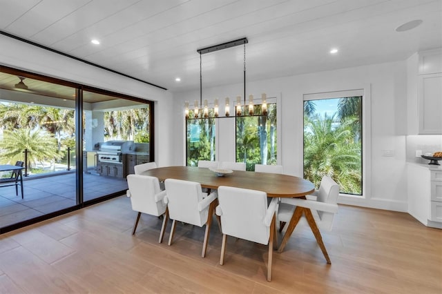 dining area featuring light hardwood / wood-style floors and a notable chandelier