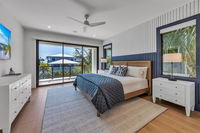 bedroom with light hardwood / wood-style flooring, access to outside, and ceiling fan