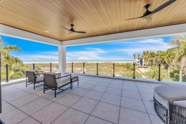 view of patio with a water view, an outdoor hangout area, and ceiling fan