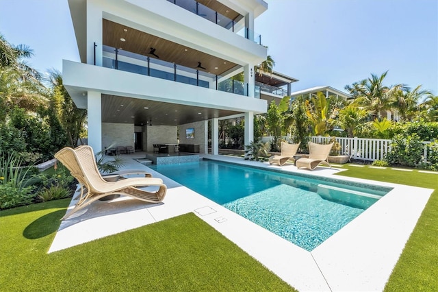 view of pool featuring a patio area and a yard